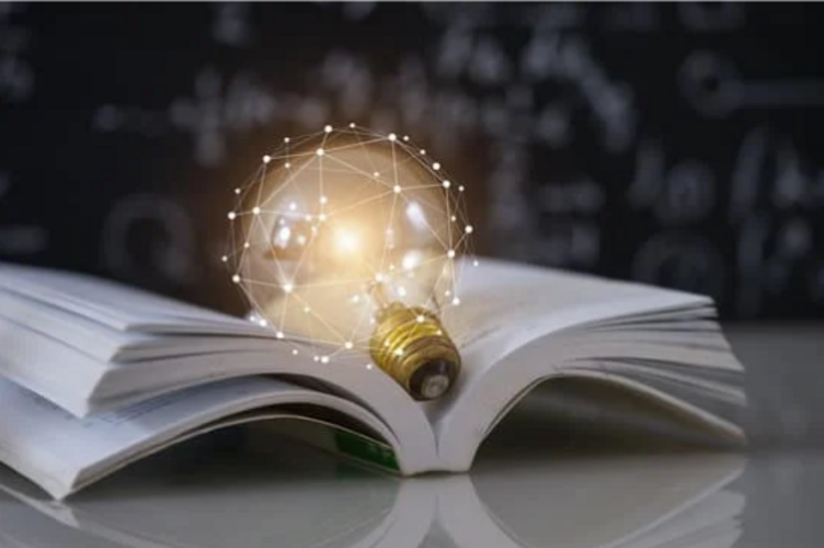 Auf diesem Bild ist ein aufgeschlagenes Buch mit einer leuchtenden Glühbirne zu sehen.